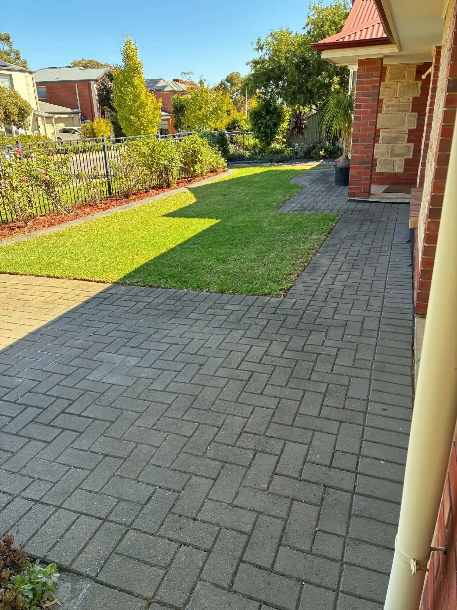 The same front paving with the weeds cleared from between the pavers.